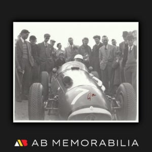 Stirling Moss signed original 1954 British Grand Prix photograph seated in the number 7 Maserati 250F at Silverstone